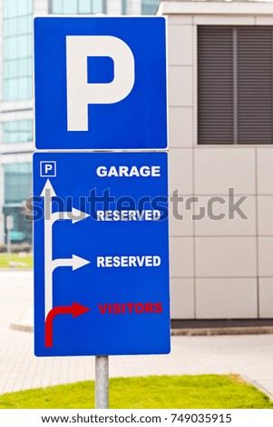 Blue park and garage sign on parking lot