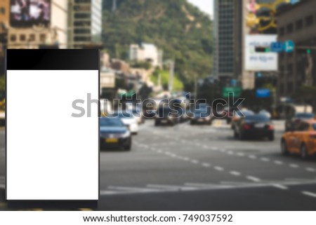 Blank billboard for information on bus stop beside the road, traffic road blurred background ,commercial, marketing and advertisement concept