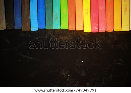 colorful chalk arrange on top with black background