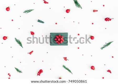 Christmas composition. Gift box, christmas tree branches, red decorations on white background. Flat lay, top view, copy space