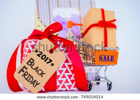 Black Friday online shopping concept. Shopping cart and gift box on white background.