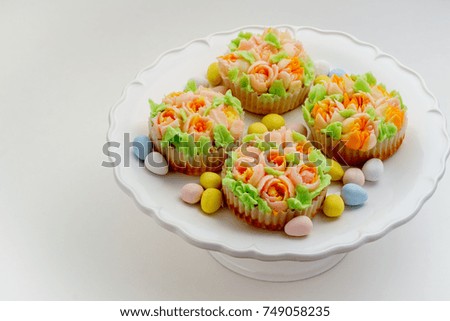 Top view decorated cupcakes with Easter eggs on white Background