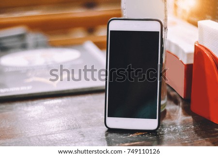 Online banking with mobile,Shopping online by smart phone and shopping in super market,People are playing smart phone on line social network in restaurant