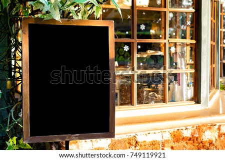 Blank wooden square blackbord photo frame modern interior design decorated with orange brick wall and christmas theme window glass  with copy space for text or image.