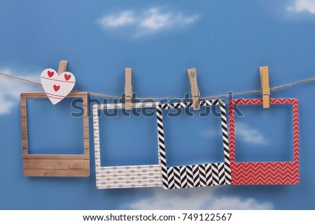 Photo Frame hanging on the rope with sky background