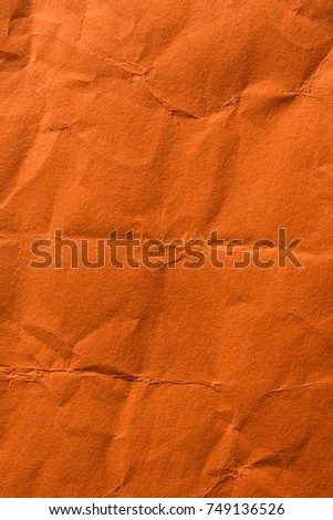 Wrinkled and crumpled orange tissue wrapping paper.