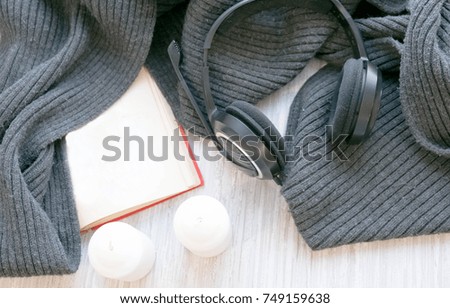 The laptop working and listen music on the white bed and coffee with marshmallow, warm knitted sweater in the sunny day. Cozy winter home morning holiday. Music and Lifestyle Concept.