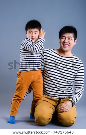 Dad and son, studio portrait