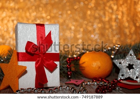  beautiful Christmas background with fir twigs and gift on shiny background