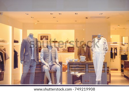 shop window with clothes, street view through glass. Royalty-Free Stock Photo #749219908