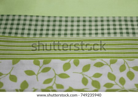 Multicolored cuts of fabric against the background of boards