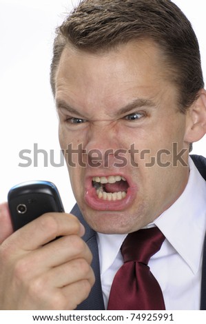 Angry business man yells into cell phone Royalty-Free Stock Photo #74925991