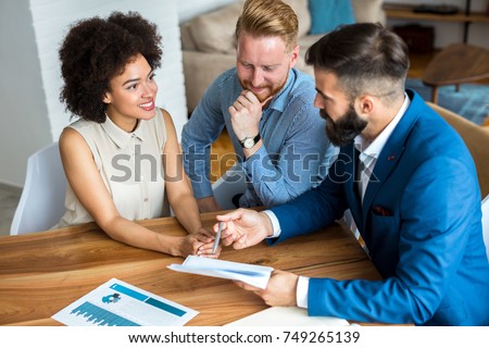 Young couple with a real estate agent. Buying new house.