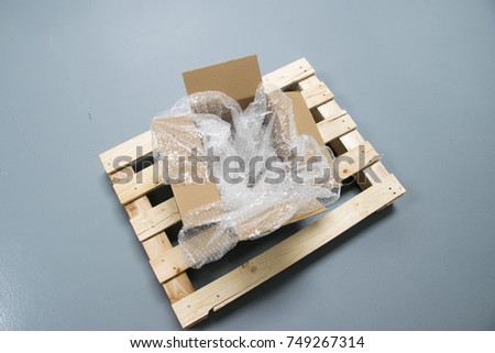 Plastic Bubble Cushioning Wrap in paper box on wood palete