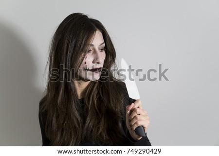 Scary woman with halloween makeup mask. Halloween themed shoot.