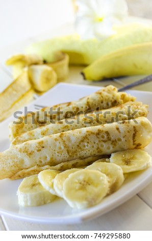 pancakes with cottage cheese and a banana on a white plate
