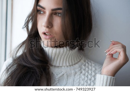 autumn, woman looks out the window                               