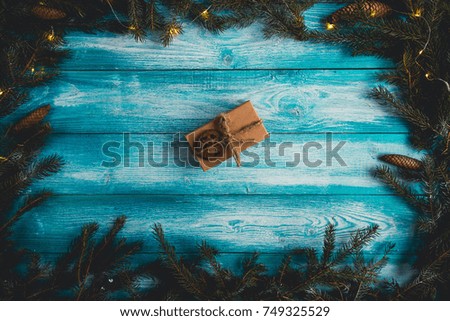 Christmas present on a blue wodden table pictured from above.