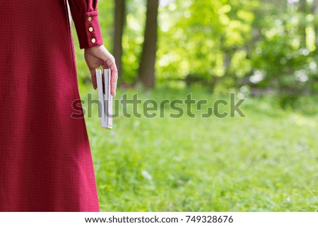 Close book in side view in young womans hand