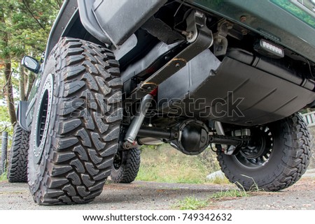 Chassis off road vehicle in the parking lot. The undercarriage of terrain car on way in nature.  Royalty-Free Stock Photo #749342632