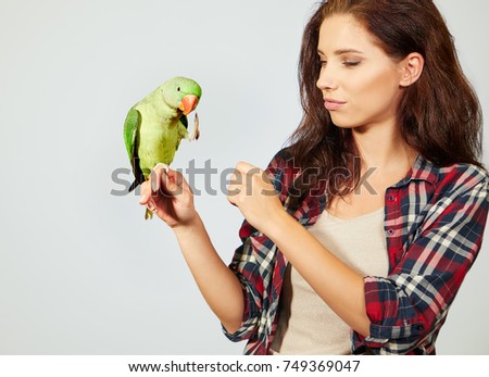 Woman feeding parrots. isolated shoot