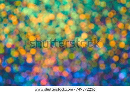 Blur bright multicolored lights on a blue background. Christmas texture for greeting cards. A ready-made idea for your design and text. Glitter background                               