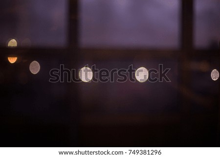 Blurred lights of the evening city through the window