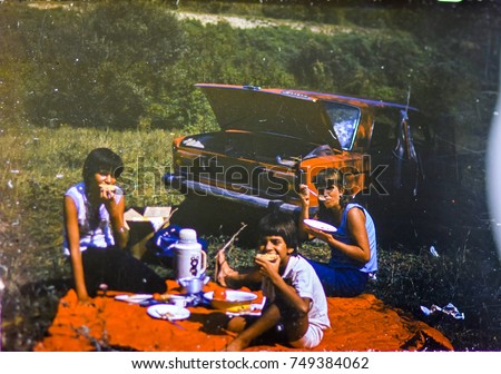 USSR, LENINGRAD - CIRCA 1983: Vintage photo of family car trip vacation picnic scene