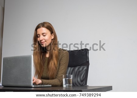 woman office business sitting at table with notebook and multimedia projector