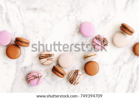 Beautiful variety of macaroons on marble background. Stylish arrangement sweet. Flat lay, top view.  Royalty-Free Stock Photo #749394709