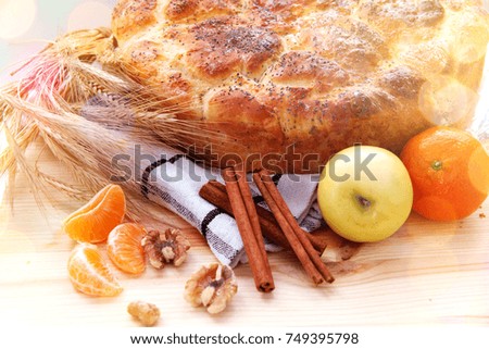  Christmas cookies with bread, cinnamon sticks, nuts, apple, orange 
