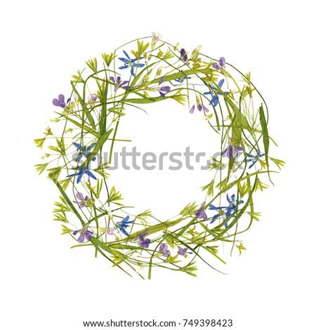 Flowers composition. Round frame made of pressed and dried flowers on beige background