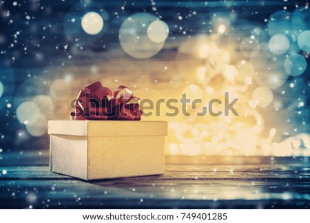 Old wooden planks with christmas decoration. Brown background with gift box