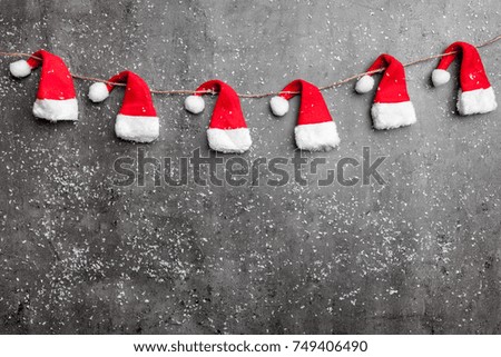 Traditional Christmas Santa hats on rustic background with copy space