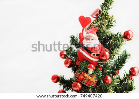 Christmas Background wit Fir Tree, Santa Claus Figure Holding a Heart and Red Bells Isolated on White Background. Holidays Greetings Card, Merry Christmas and Happy New Year theme, copy space for text