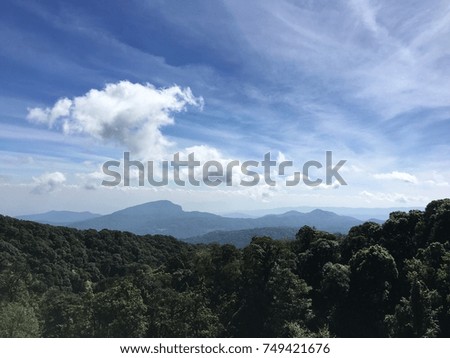 High peak mountain in morning time. Beautiful natural landscape covered with forest and a cloudy sky