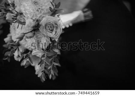 beautiful bridal bouquet of bride lies on the table. black and white photo