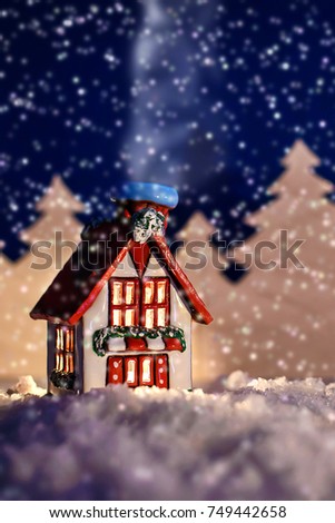 Beautiful Christmas fairy-tale picture of a winter cabin in a forest at night in the snow