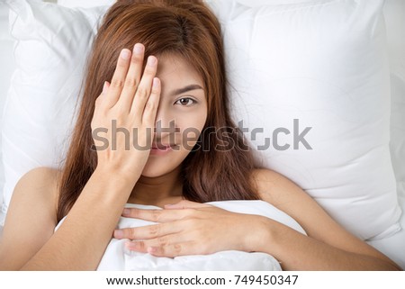 Young asian woman sleeping in her bed at night, she is resting with eyes closed.