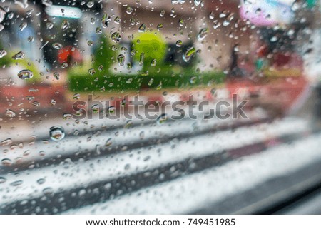 Raindrop on Windshield and car mirror on Traffic in rainy season