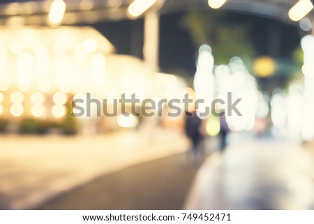 blurred people walking in the street night
