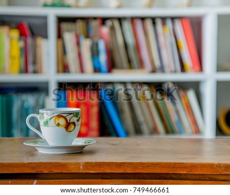 ancient vintage coffee cup in blur vintage room interior
