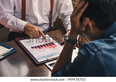 Stressed business man. Team businessman with chart in the fall. economy or stock market going down.Businessman is disappointed from losing in stock exchange. Royalty-Free Stock Photo #749478703