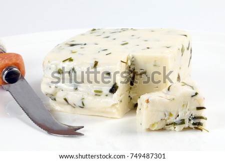 Fresh Cheese with Chive Herbs on black slate stone 

 Royalty-Free Stock Photo #749487301