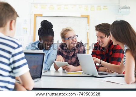 Group Of Teenage Students Collaborating On Project In IT Class Royalty-Free Stock Photo #749503528