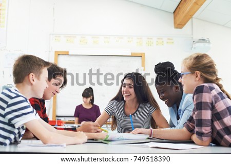 Group Of Teenage Students Collaborating On Project In Classroom Royalty-Free Stock Photo #749518390