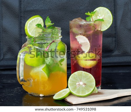 Passion-Fruit-Mojito-and-Starwberry-Mojito with slice lime and mint leaves on cutting board