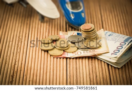 Euro and South Korean won banknote and coins on brown wooden plank. , use as Business and finance concept or Investing in Mass Transit and Military