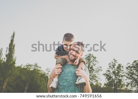 dad with son having fun outside. hipster style. casual clothes. concept of happy family Royalty-Free Stock Photo #749591656