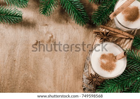 Traditional Homemade Winter Eggnog Cocktail with Whipped Cream and Cinnamon for Christmas Eve and Winter Holidays. Selective Focus. Copy Space